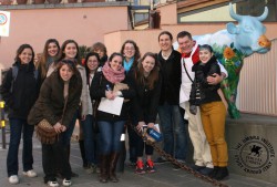 Dressed in white and red (right), world-famous butcher Dario Cecchini poses with Umbra's Sustainability class outside his shop and restaurant.