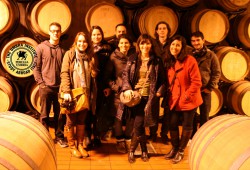 Umbra's International Marketing students stand in the Montevibiano wine cellar after a tour around the eco-winery on a field trip Friday.